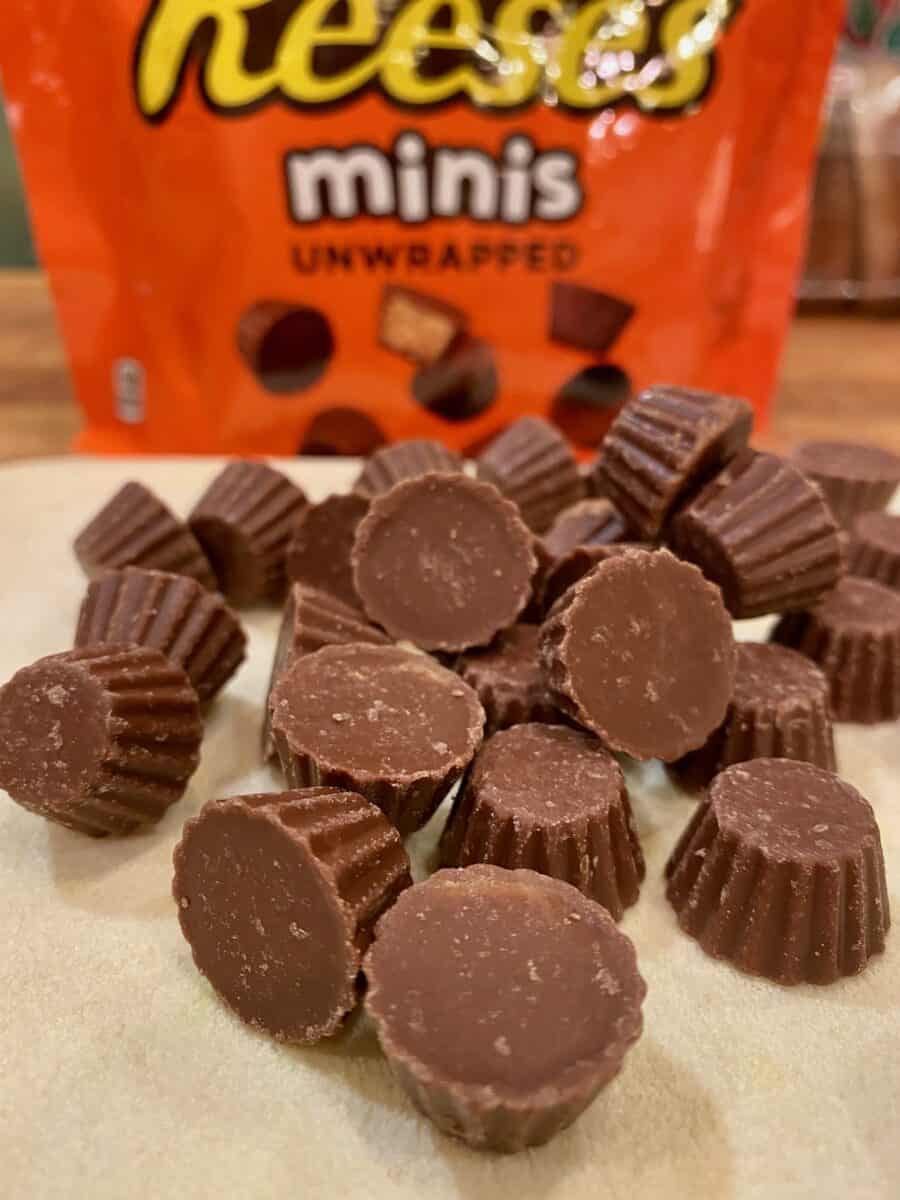 A small mound of mini Reese's minis with the package in the background