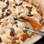 Sweet potato casserole in a baking dish with a spoon