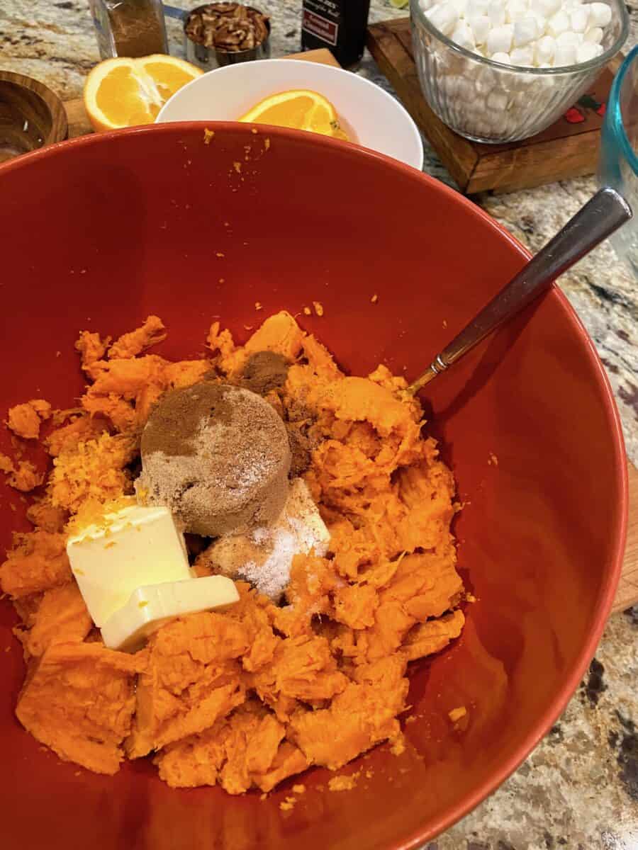 All ingredients for the casserole in a large mixing bowl with a spoon