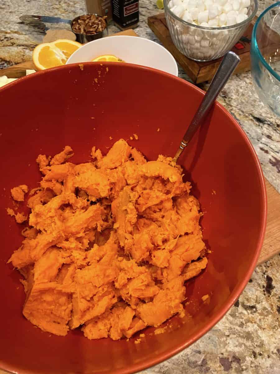 Mashed sweet potatoes in a bowl with a fork