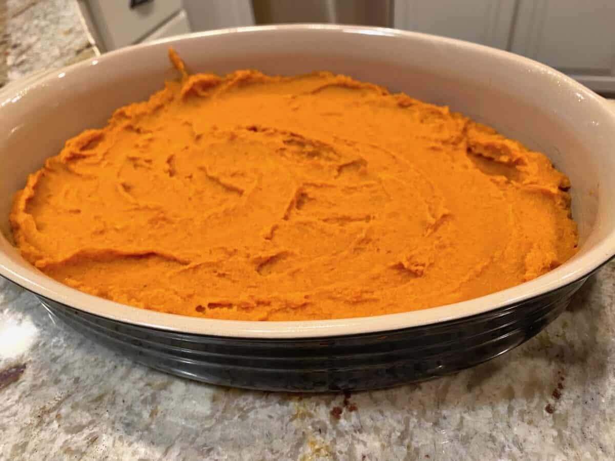 Mashed sweet potatoes in a layer in a baking dish