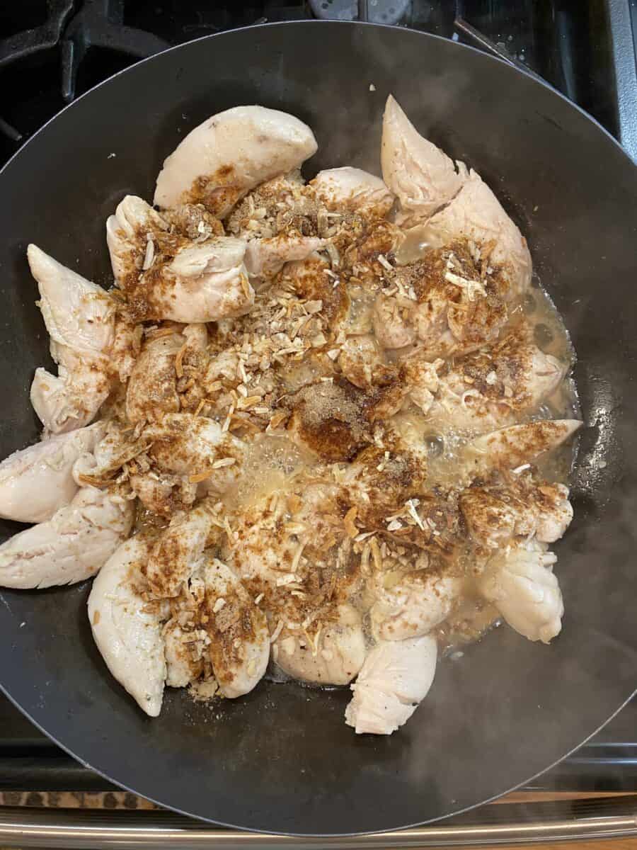 Onion soup mix sprinkled on top of cooked chicken in a skillet