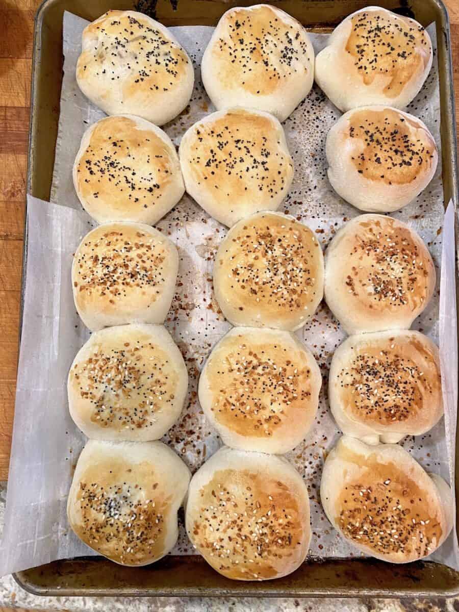 A large cookie sheet with rows of baked, grown up pigs in a blanket