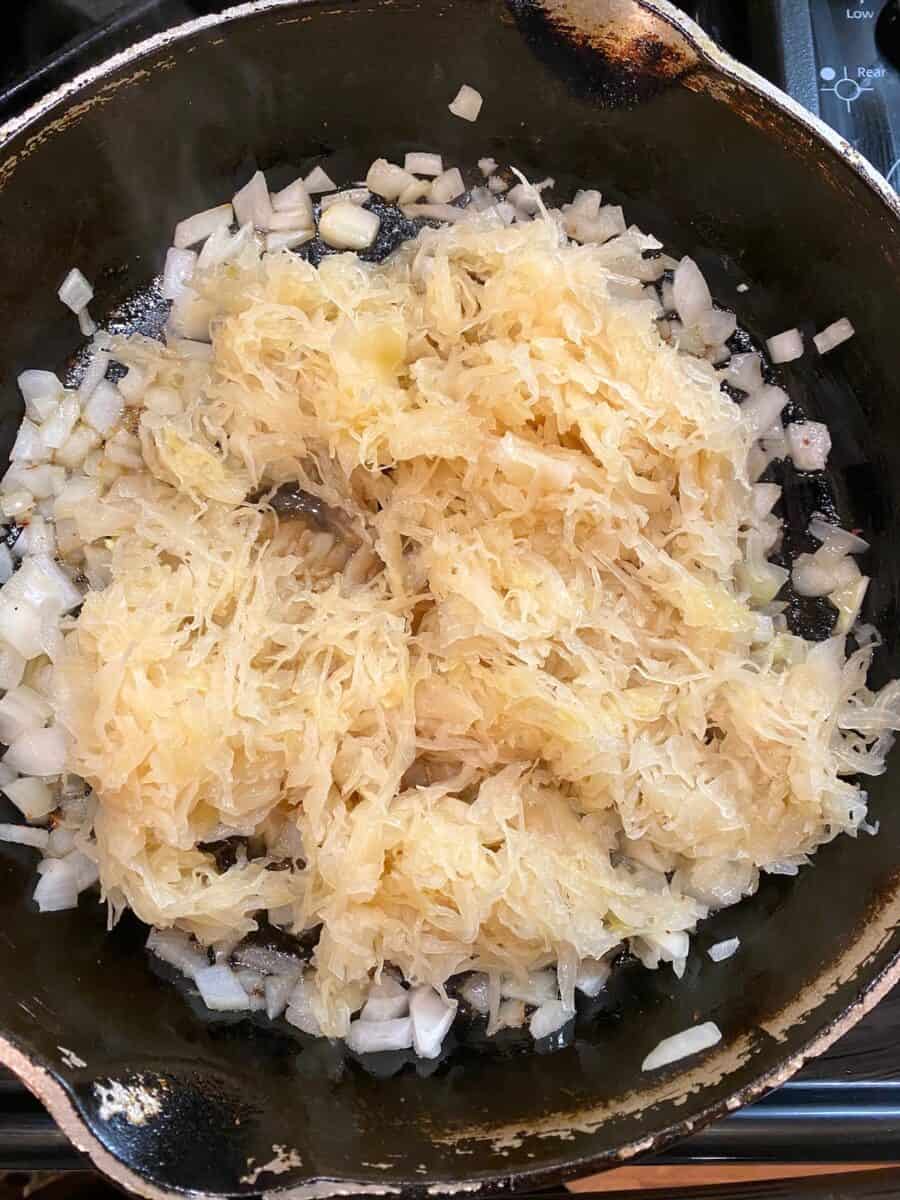 Onions and sauerkraut in a cast iron skillet 