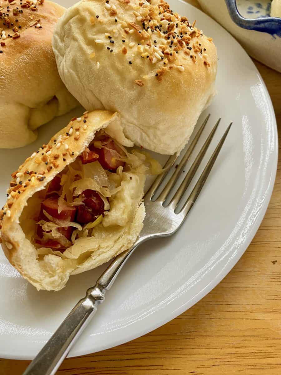 Little Smokie and sauerkraut filling in a halved portion of a dinner roll