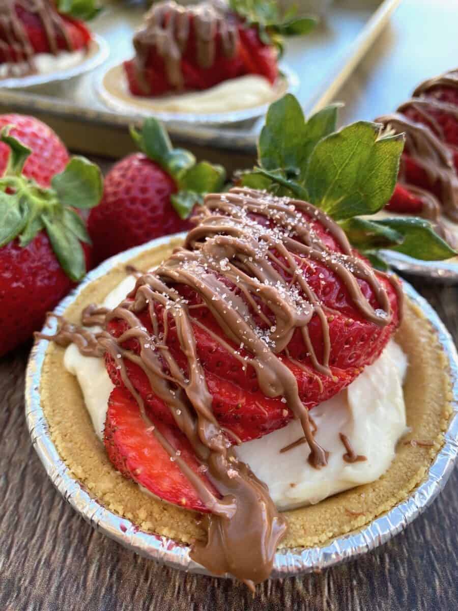 A mini strawberry pie with chocolate on top 