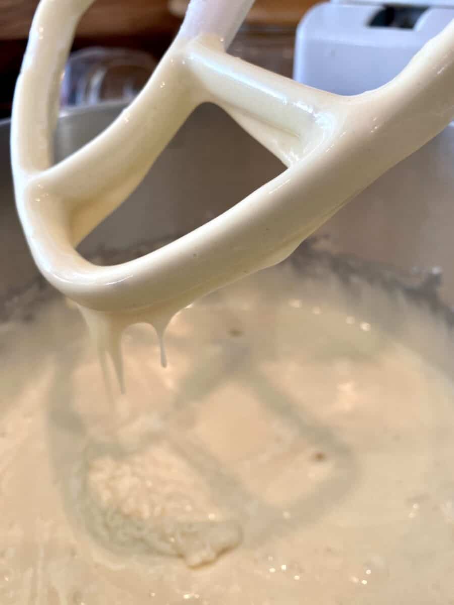 Cake batter in a mixing bowl with a beater. 