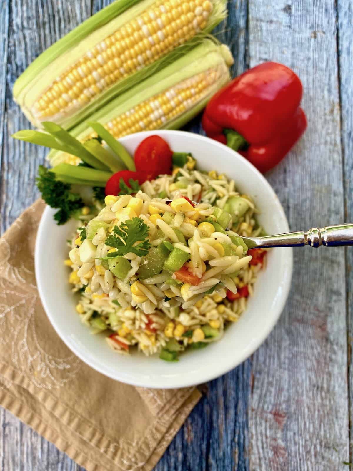 A serving of sweet corn pasta salad.