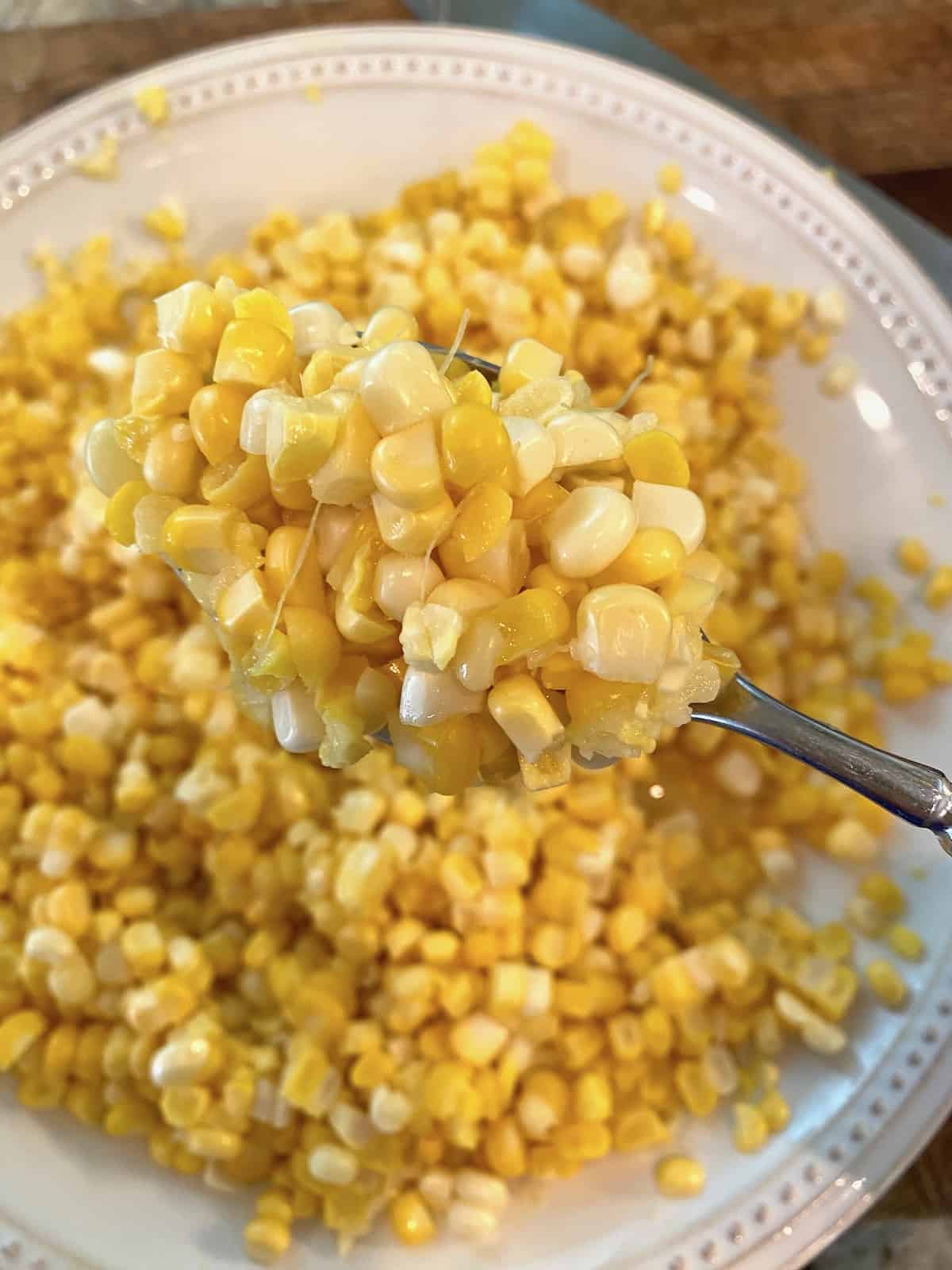 A plate full of fresh, whole kernel corn.