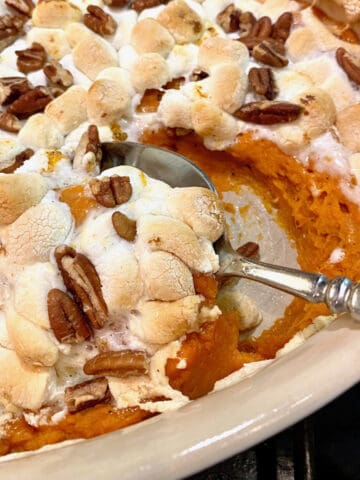 Sweet potato casserole, with a spoon scooping up a serving.