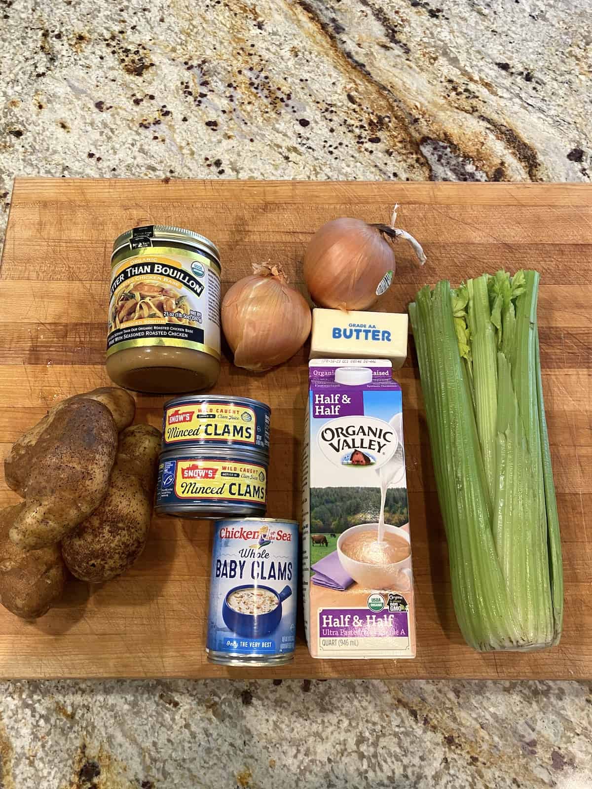 Ingredients for clam chowder on a cutting board.