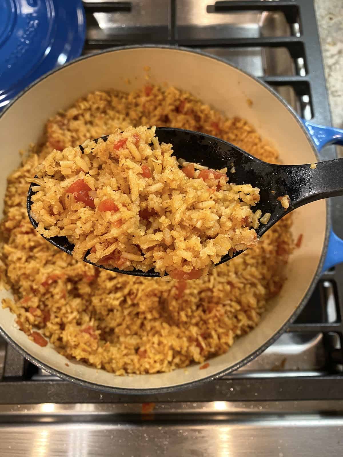 A large pot full of cooked Mexican rice.