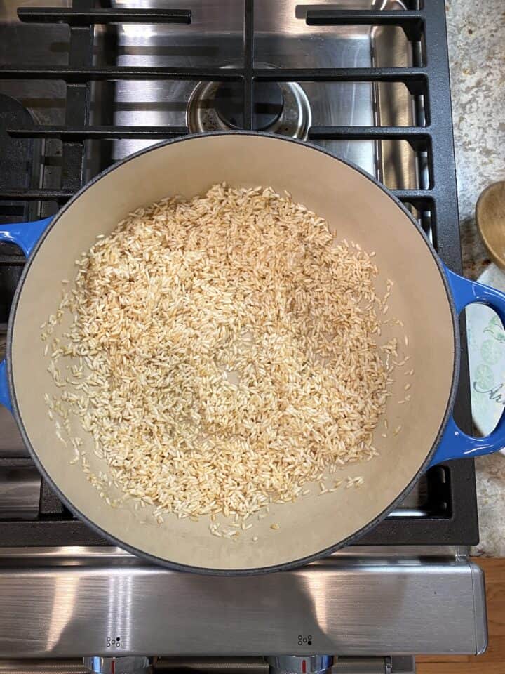 A pot of rice, halfway through the cooking and browning process.