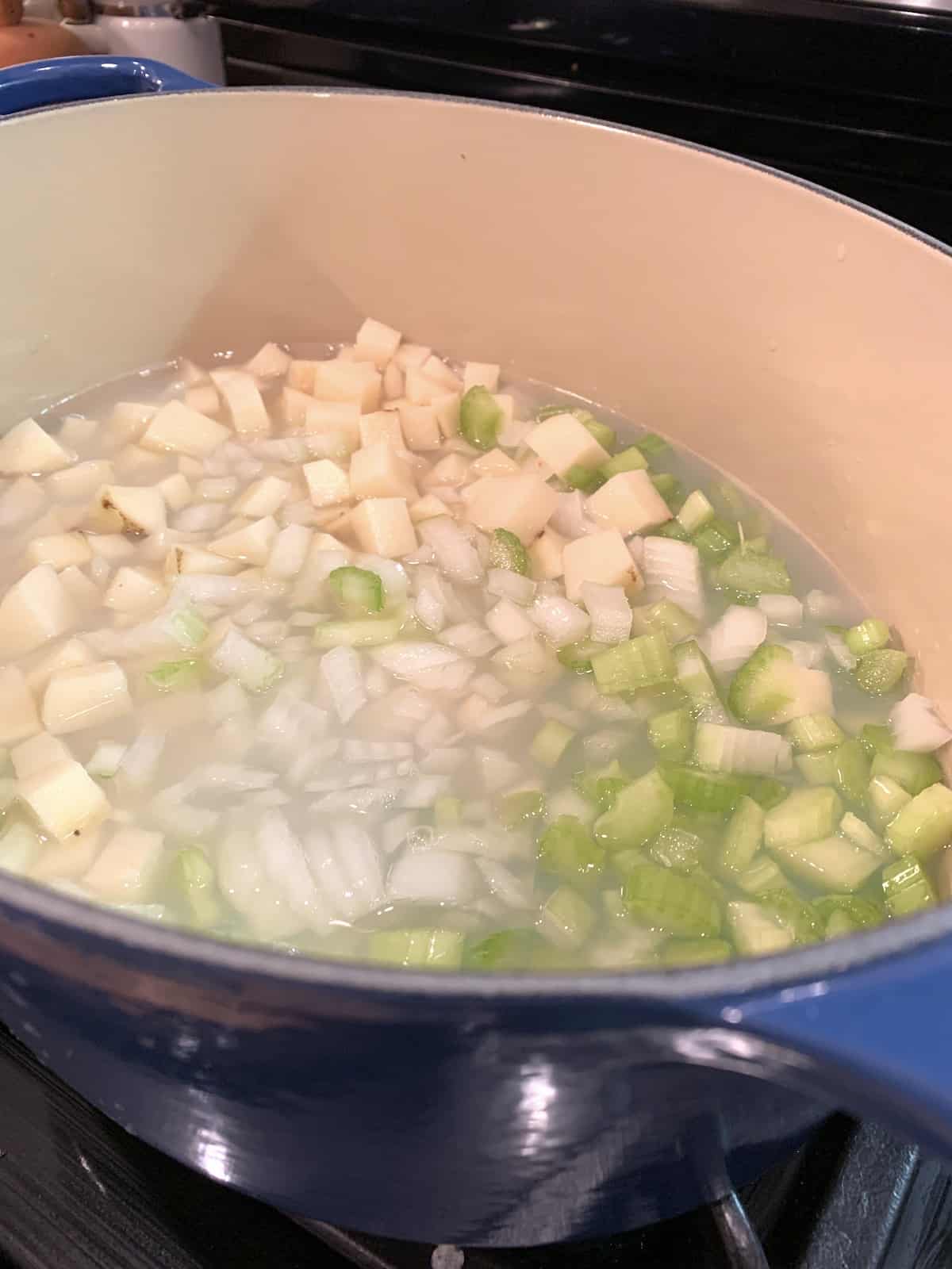 Chowder ingredients in a pot on the stove.