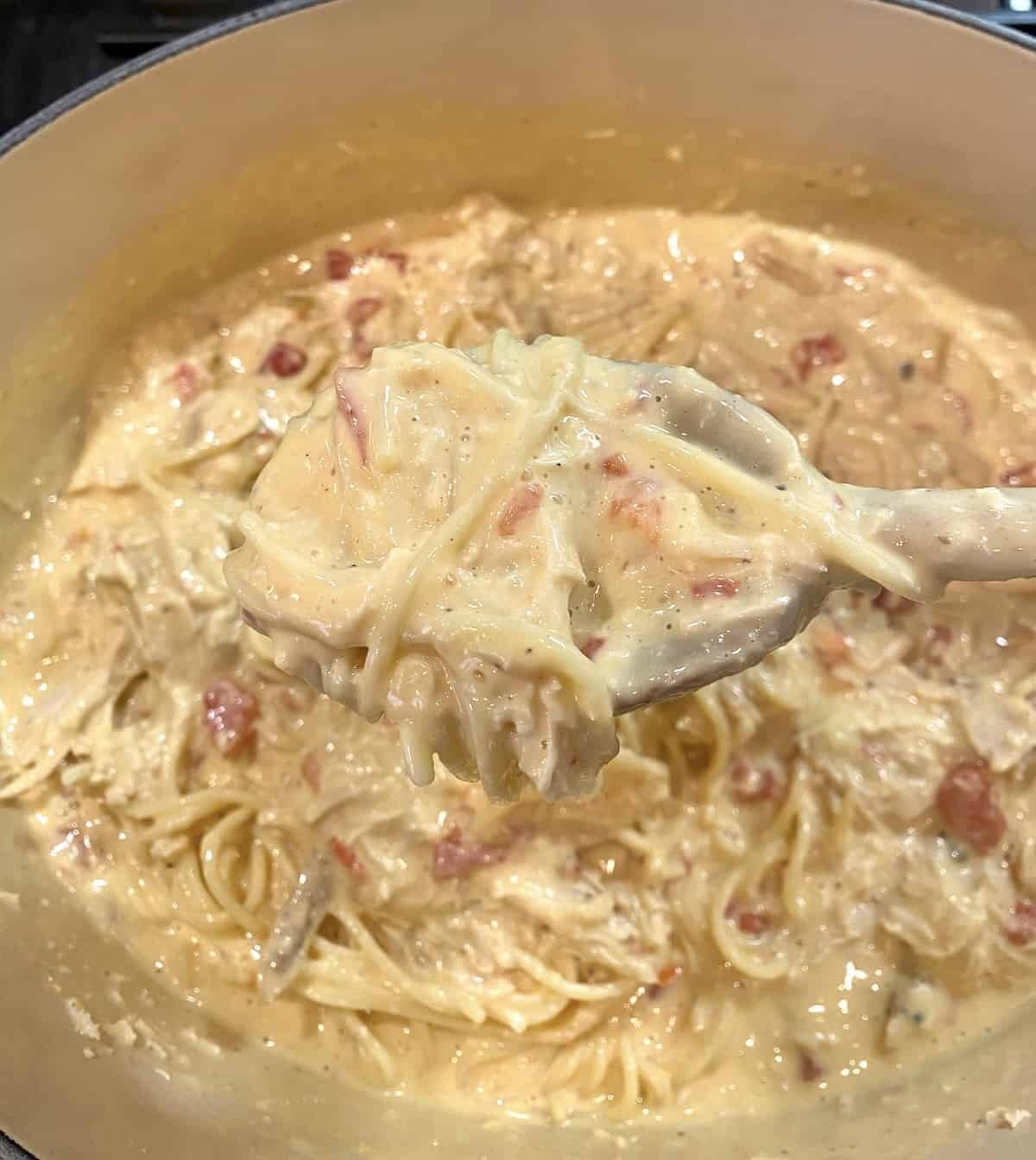 Chicken spaghetti in a sauce pan on the stove.