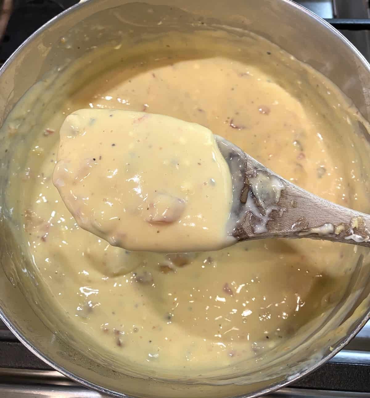 Velveeta cheese sauce in a pan on the stove.