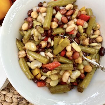 A spoon dishing up serving of bean salad.