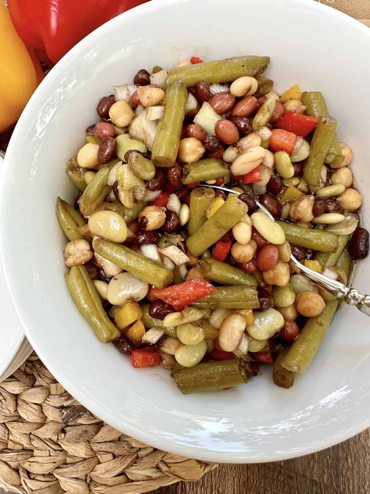 A spoon dishing up serving of bean salad.