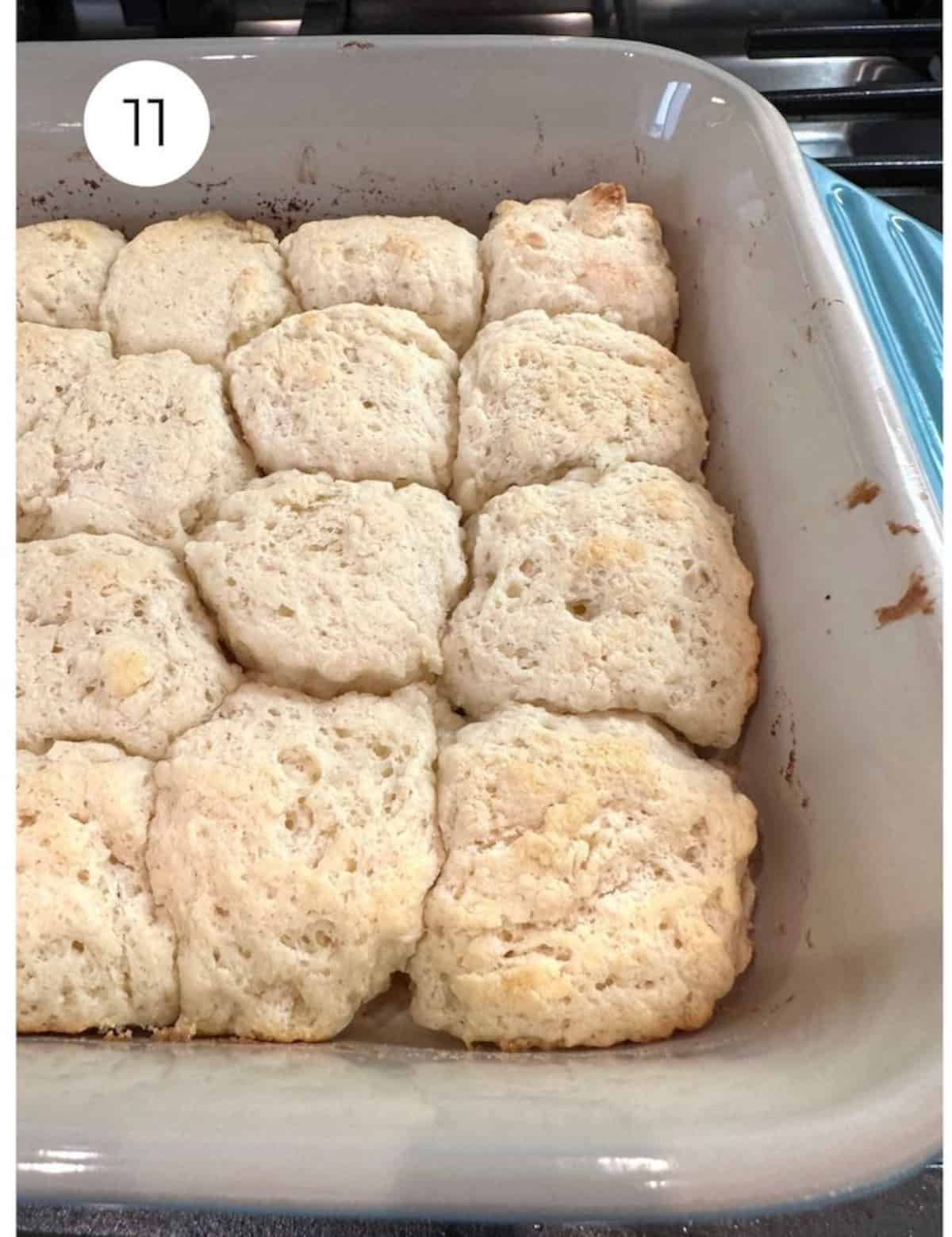 Baked biscuits in a dish on the stovetop.