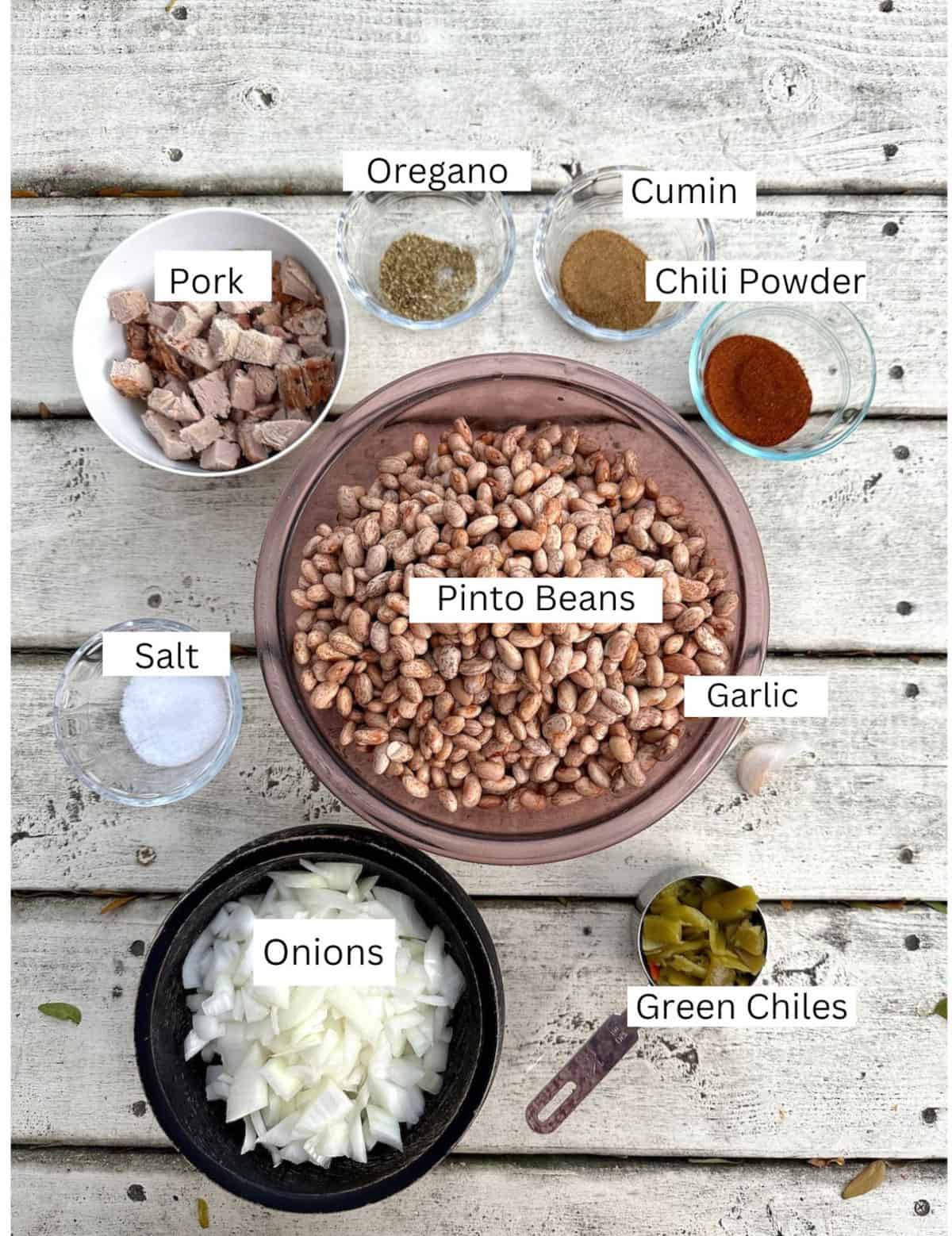 Ingredients for Pinto Bean Chili in small bowls on a table.