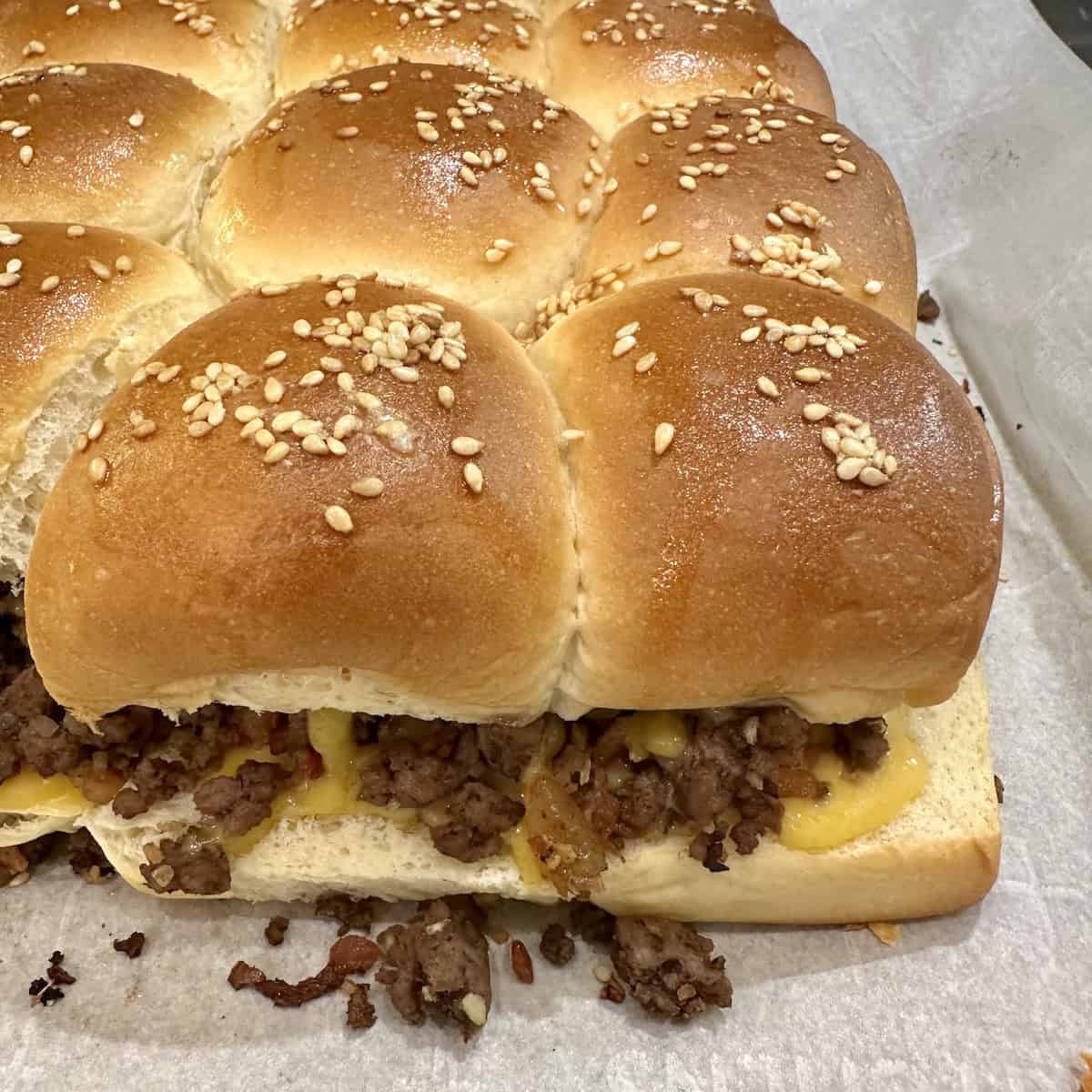 A pan of baked cheeseburger sliders.