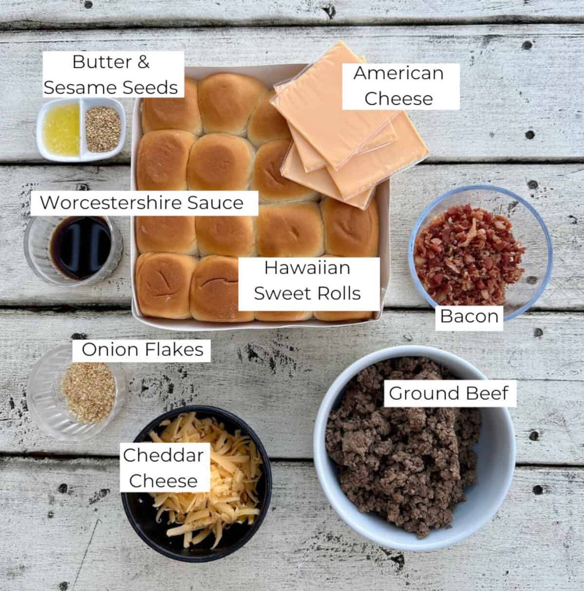 Ingredients for cheeseburger sliders in bowls on a table.
