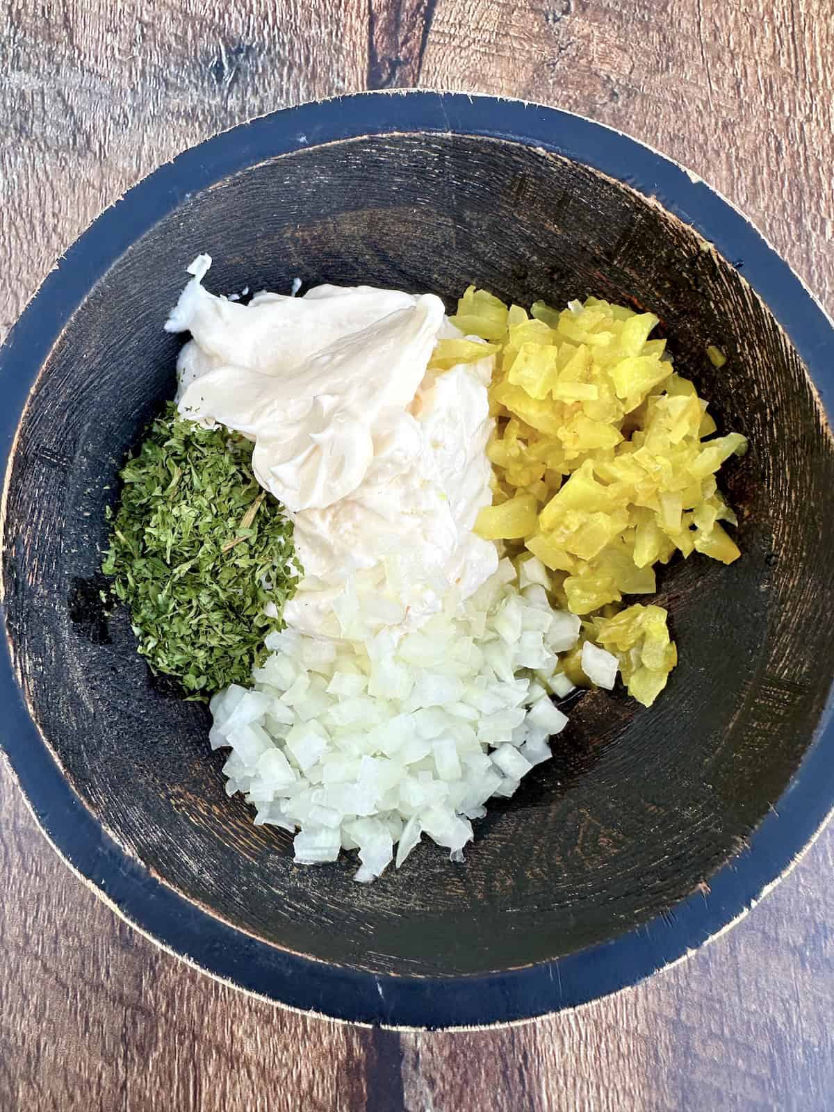 Tartar sauce ingredients in a bowl.