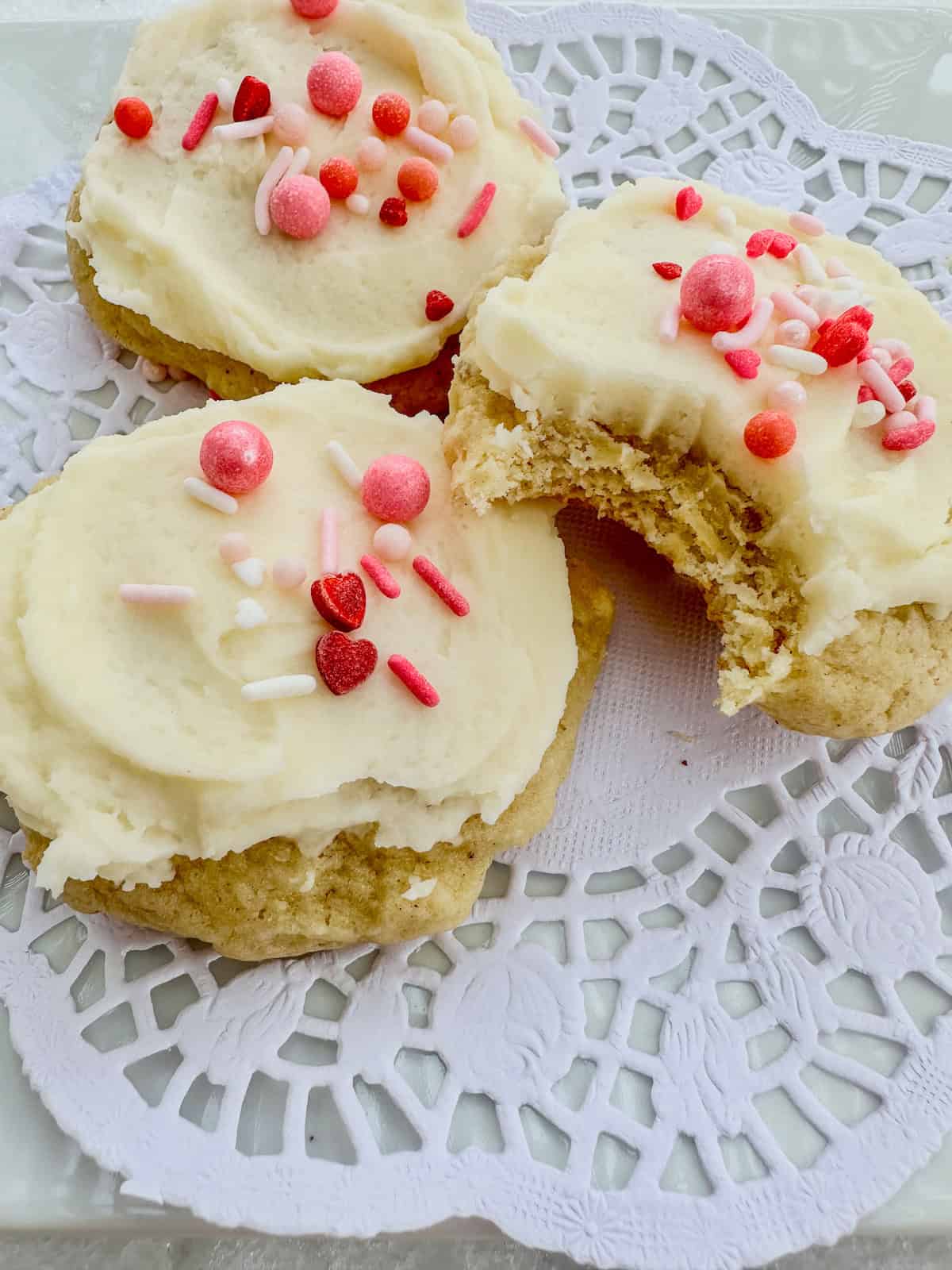 Sour cream cookies and one with a bite mark.