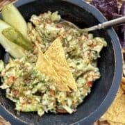 A bowl of pickle de gallo in a basket of chips.