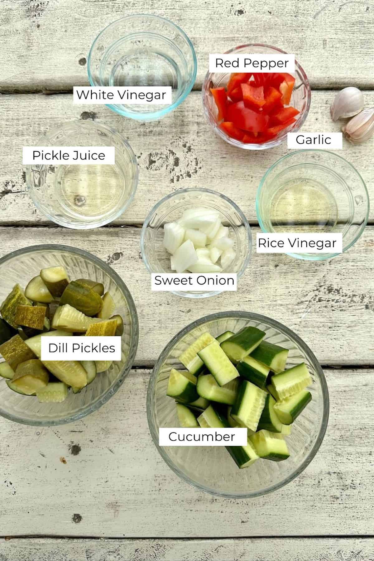 Ingredients for Pickle de Gallo in bowls on a wooden table