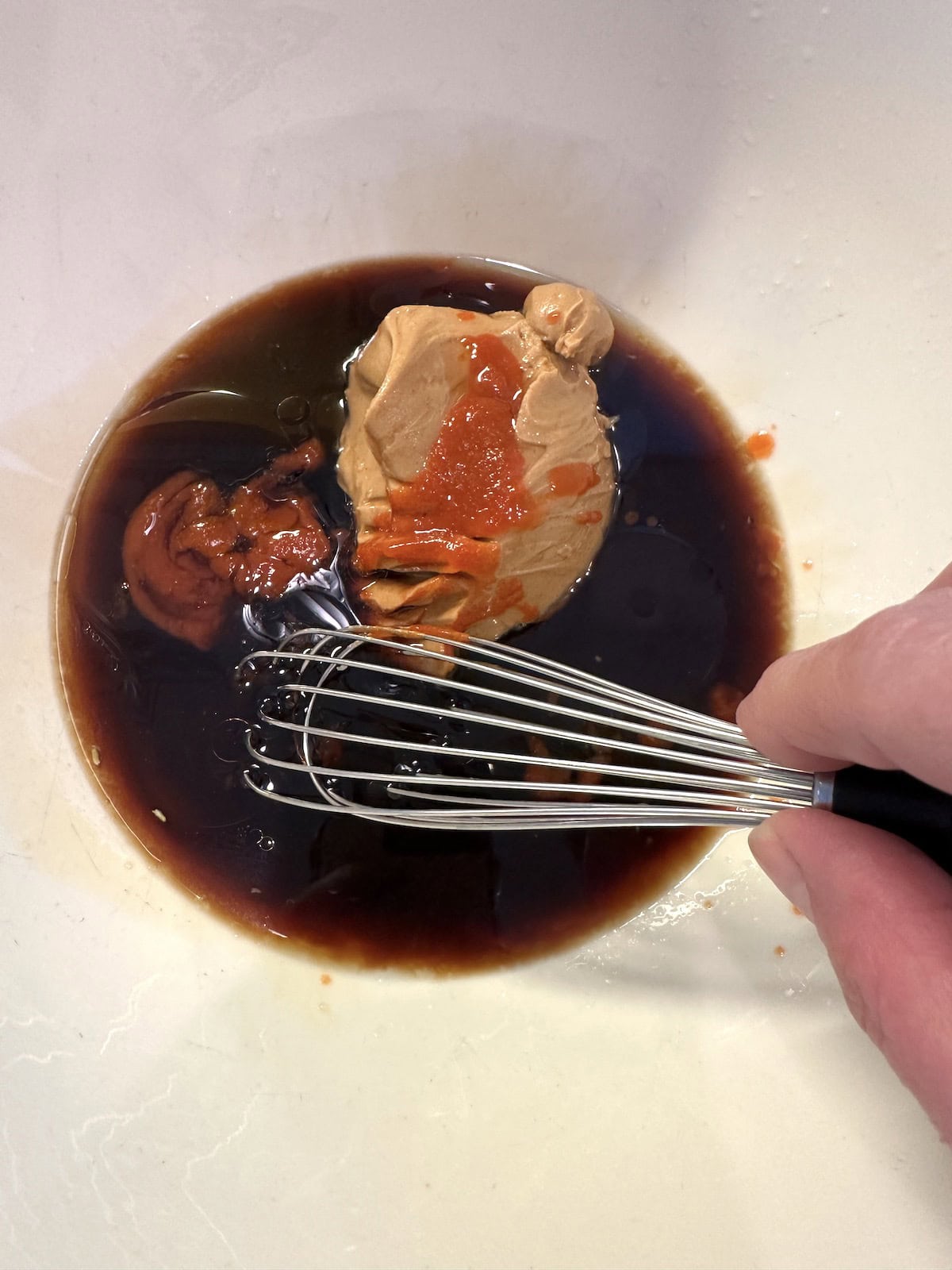 Peanut spicy noodle sauce ingredients in a bowl, not blended.