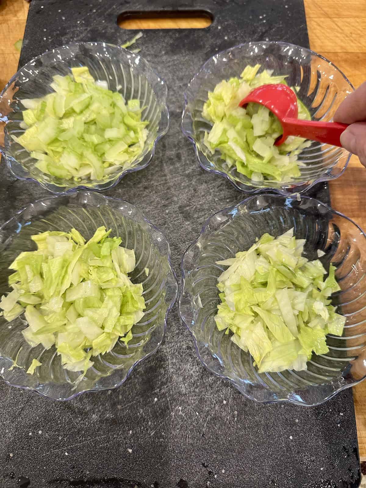 Small cups filled with lettuce and chopped celery.