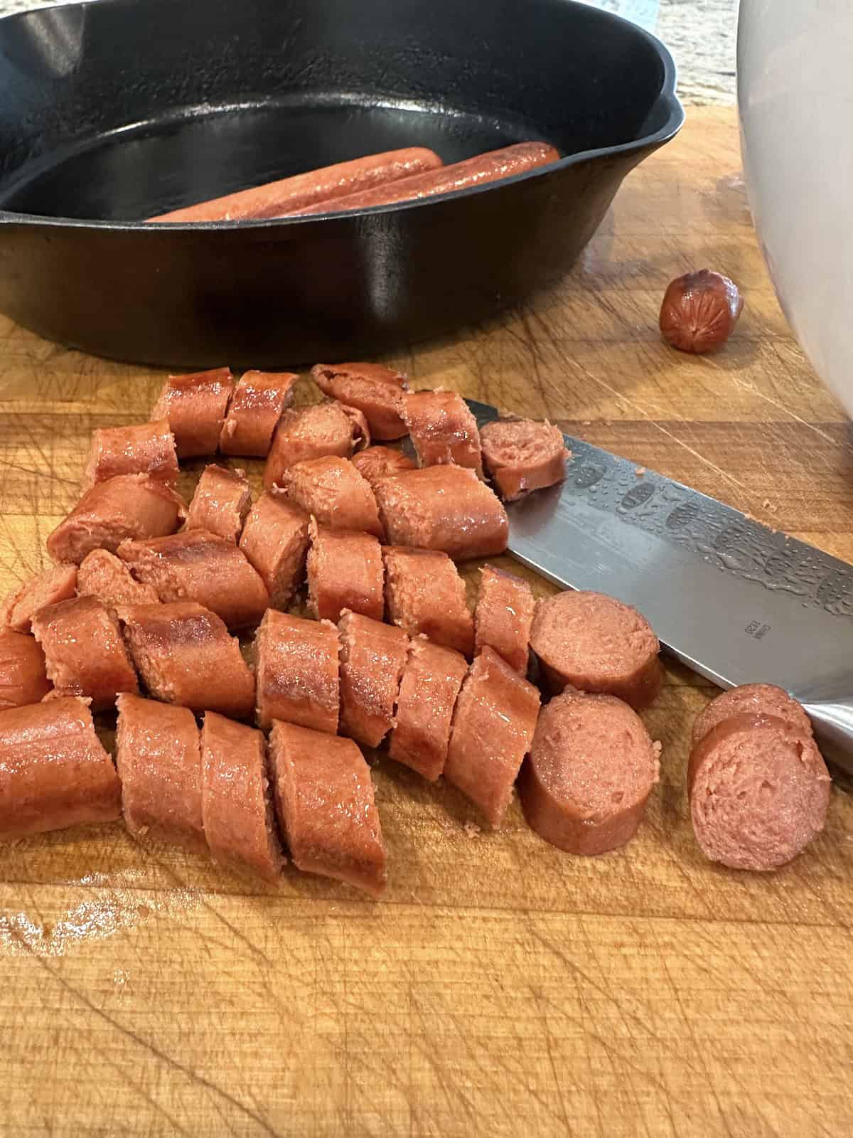 Diced hotdogs on a cutting board.