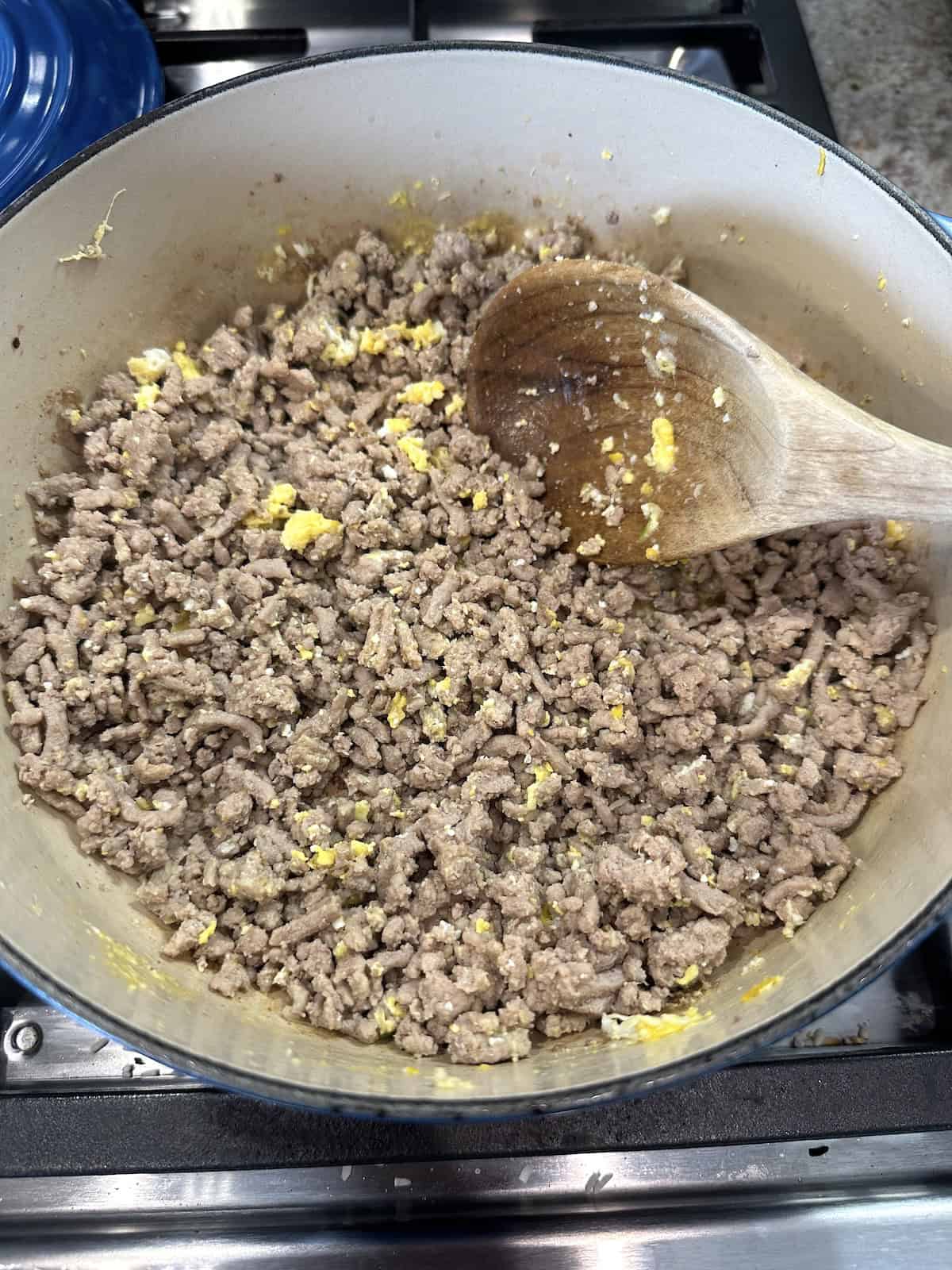 Cooked egg stirred into good ground turkey in a pan on the stove.