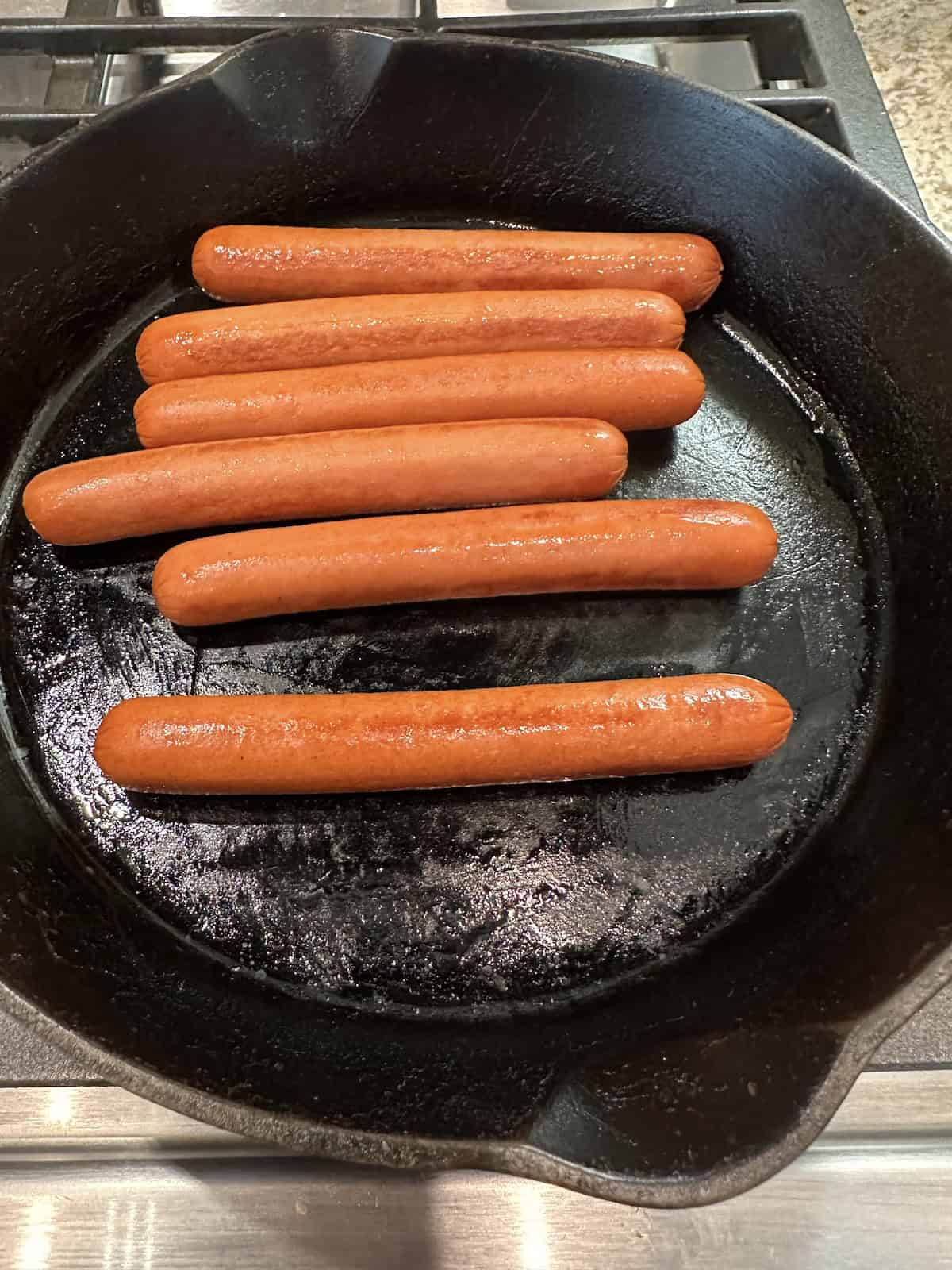 Hotdogs in a skillet.