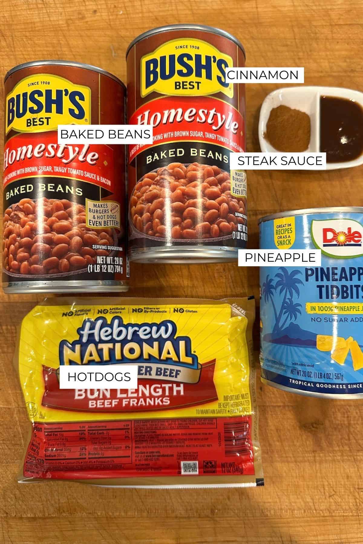 Labeled ingredients for franks and beans on a cutting board.