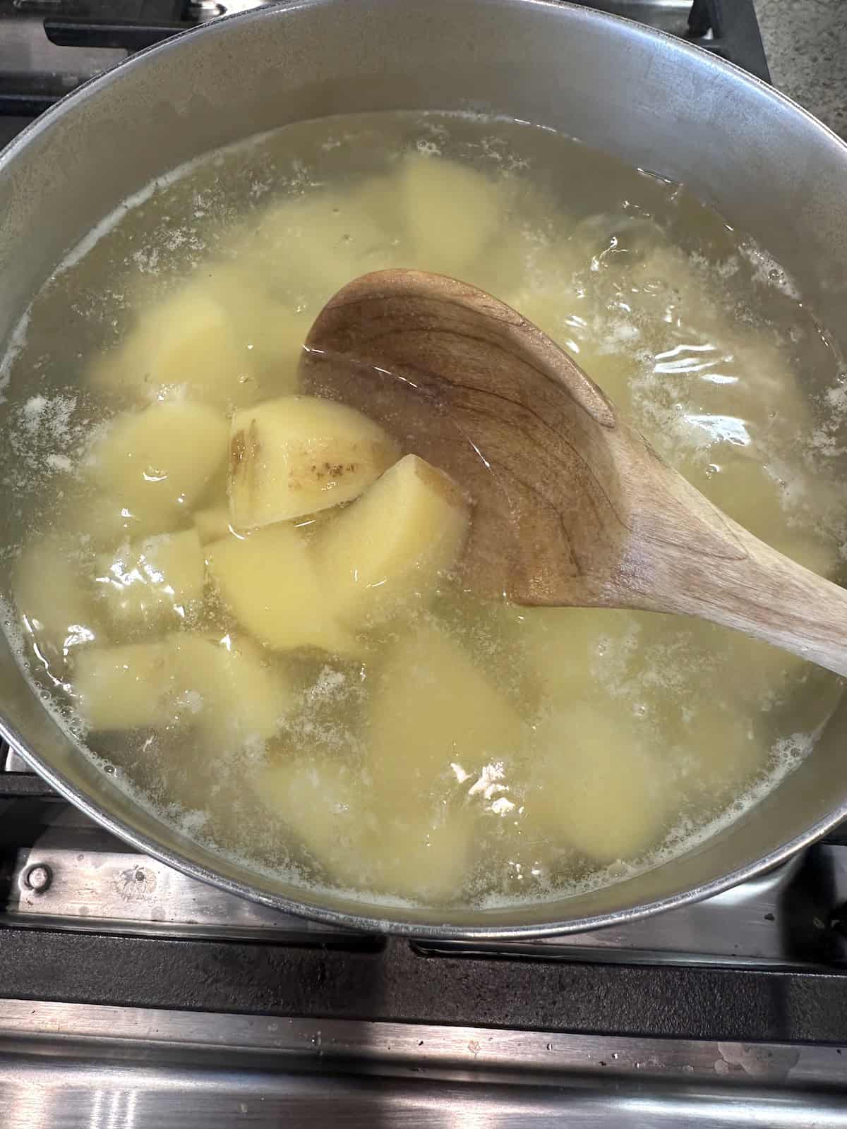 Potatoes in boiling water on the stove.