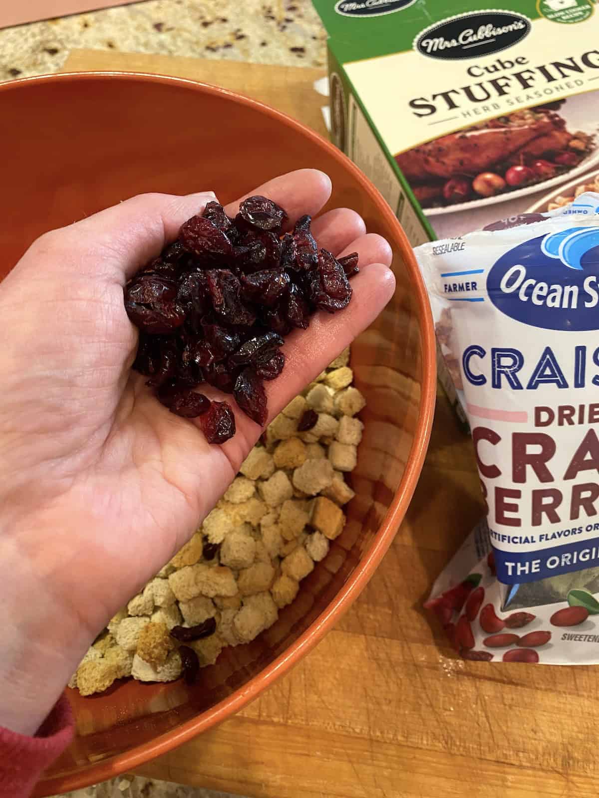 A bowl of cranberries and a bowl of stuffing mix.