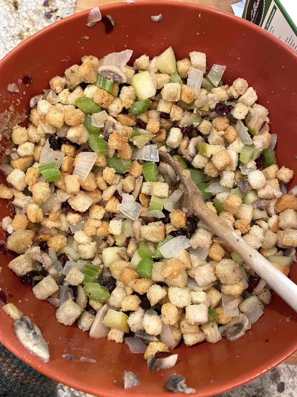 A bowl of stuffing with celery and onions.