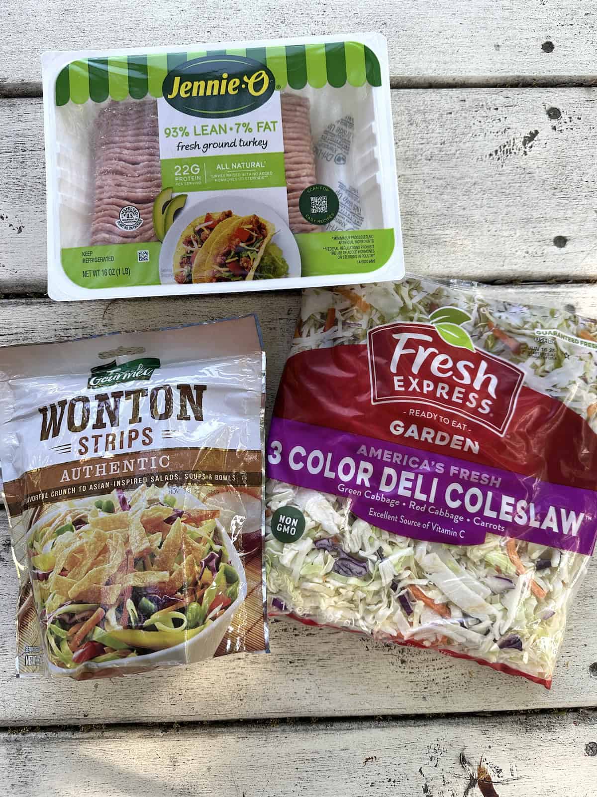 Sealed packages of ground turkey, wonton strips and coleslaw mix.