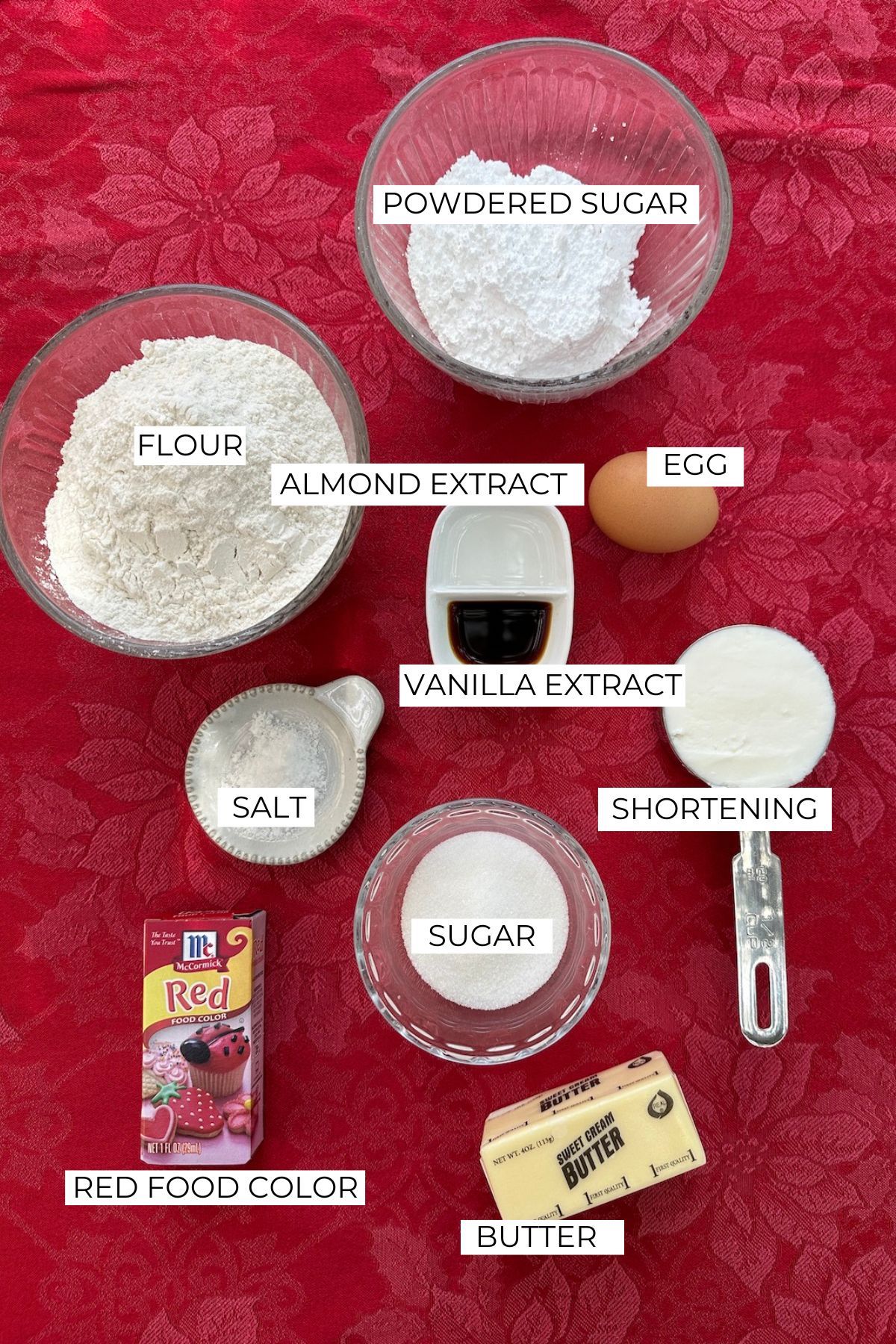 Ingredients for Christmas candy cane cookies labeled on a table.