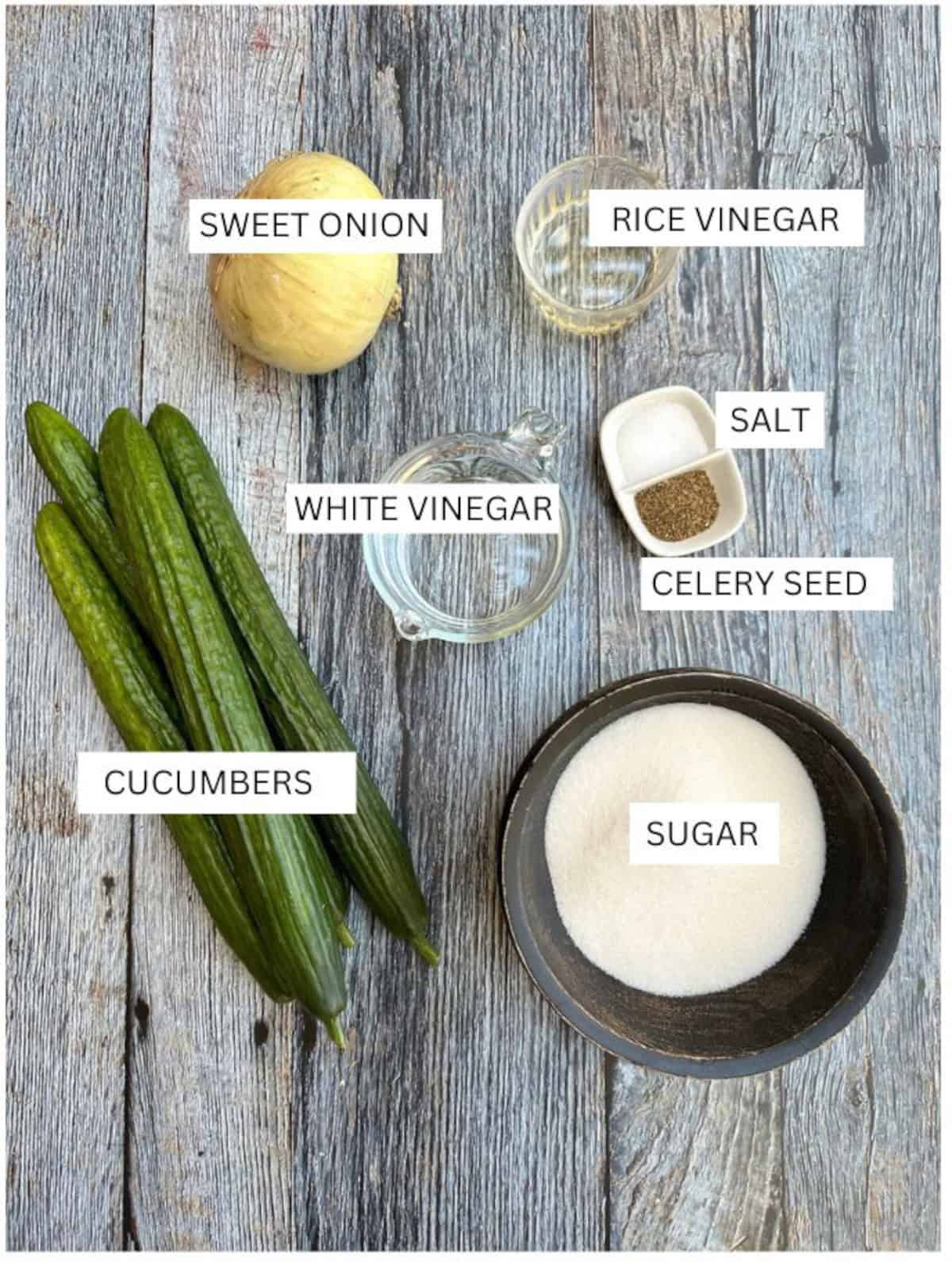 Labeled ingredients for refrigerator pickles on a wooden table.