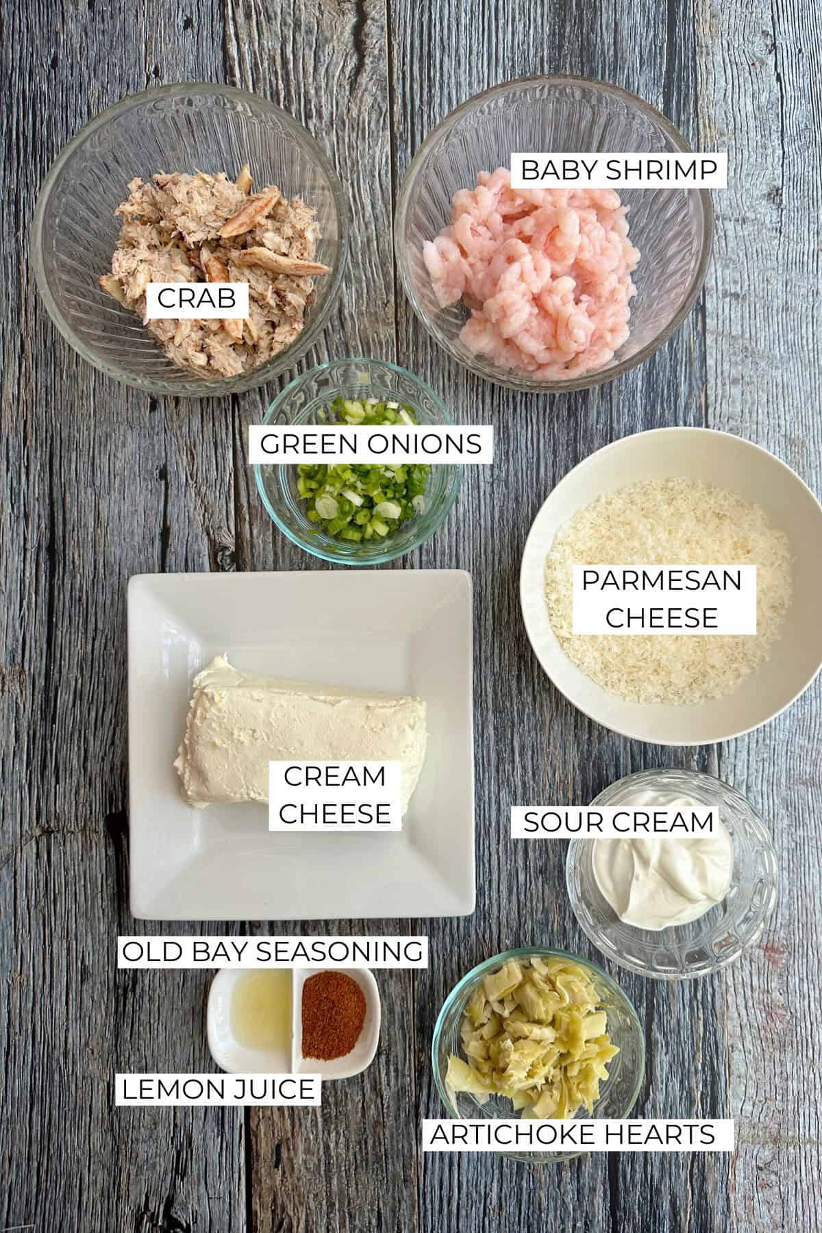 Shrimp and crab dip ingredients labeled on a wooden table.