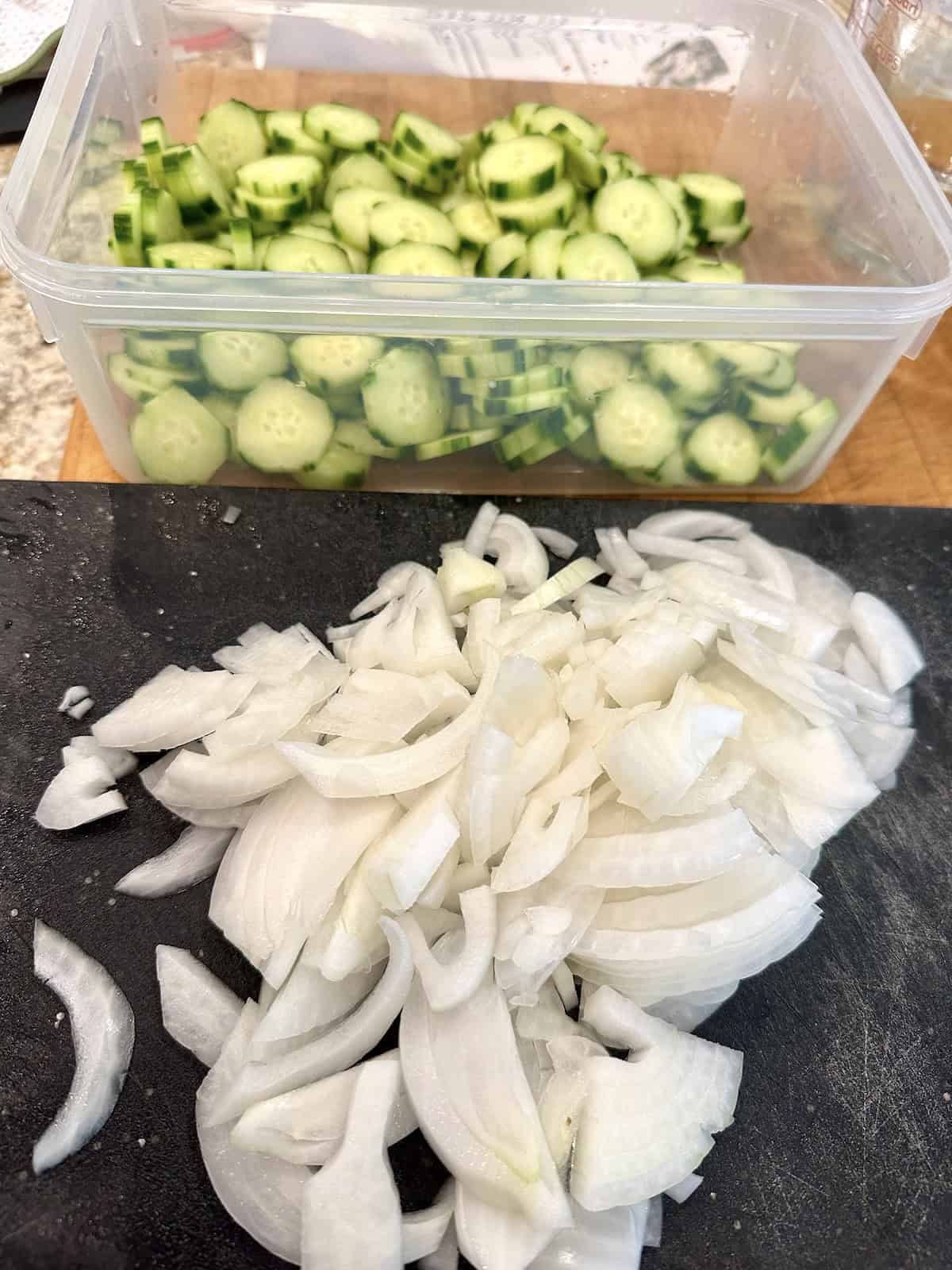 Sliced onions and cucumbers for refrigerator pickles.