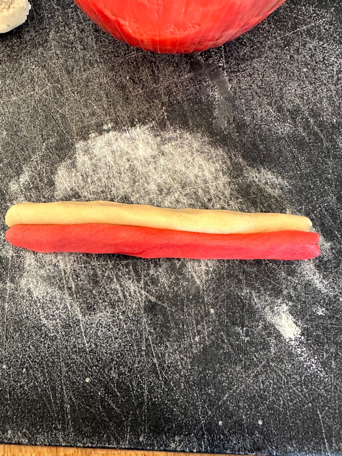 Christmas candy cane cookie strips on a cutting board.