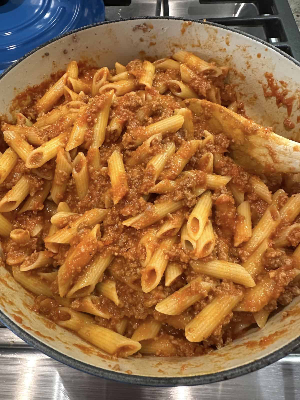 Pasta, meat and sauce for lazy lasagna in a pot on the stove.