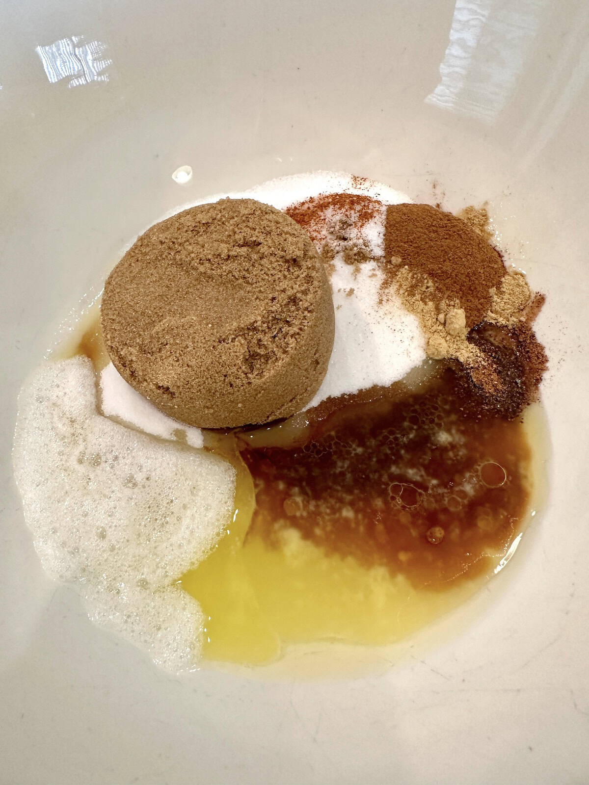 Ingredients for spiced walnuts together in a bowl.