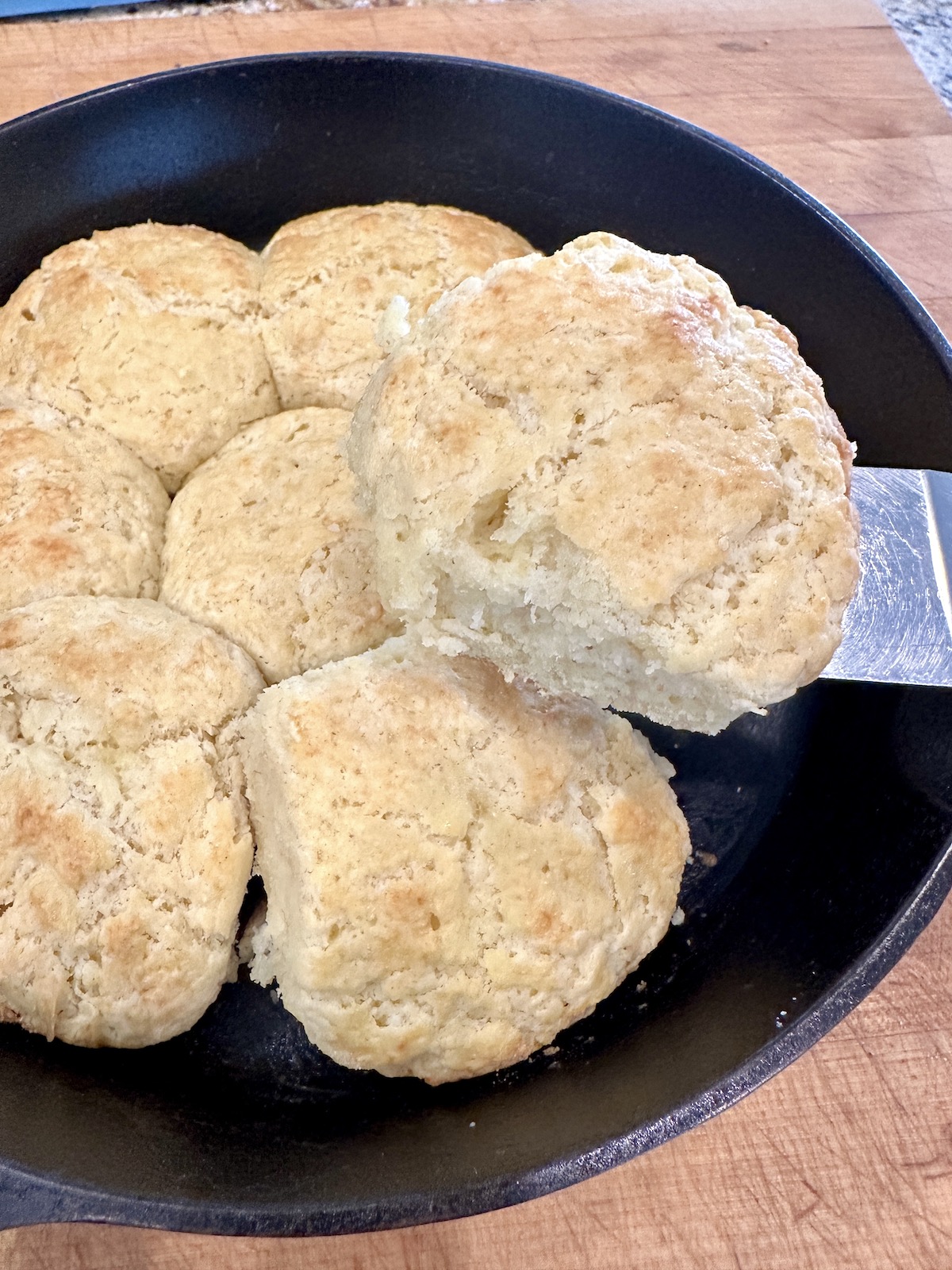 Tender, flaky, baked homemade biscuits in a skillet.