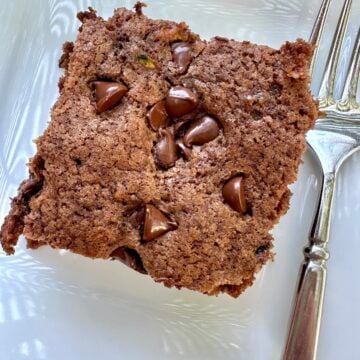 A serving of old-fashioned chocolate zucchini cake on a plate.