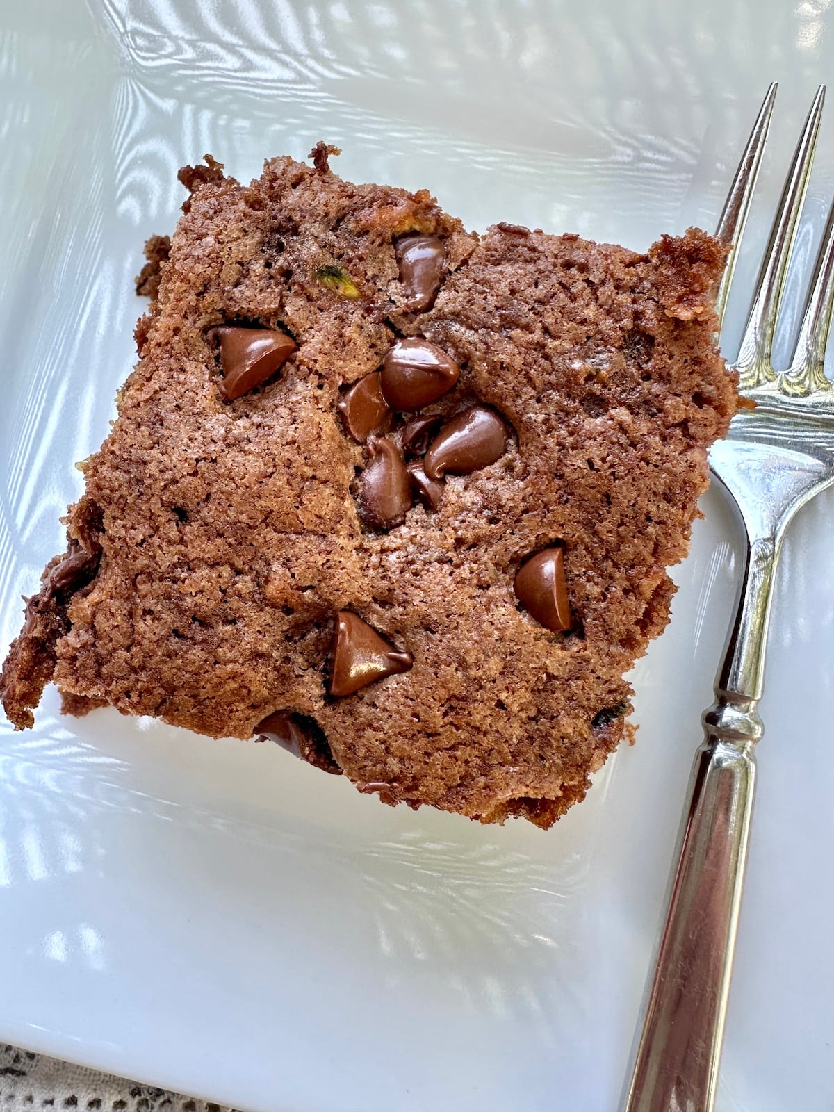 A serving of old-fashioned chocolate zucchini cake on a plate.